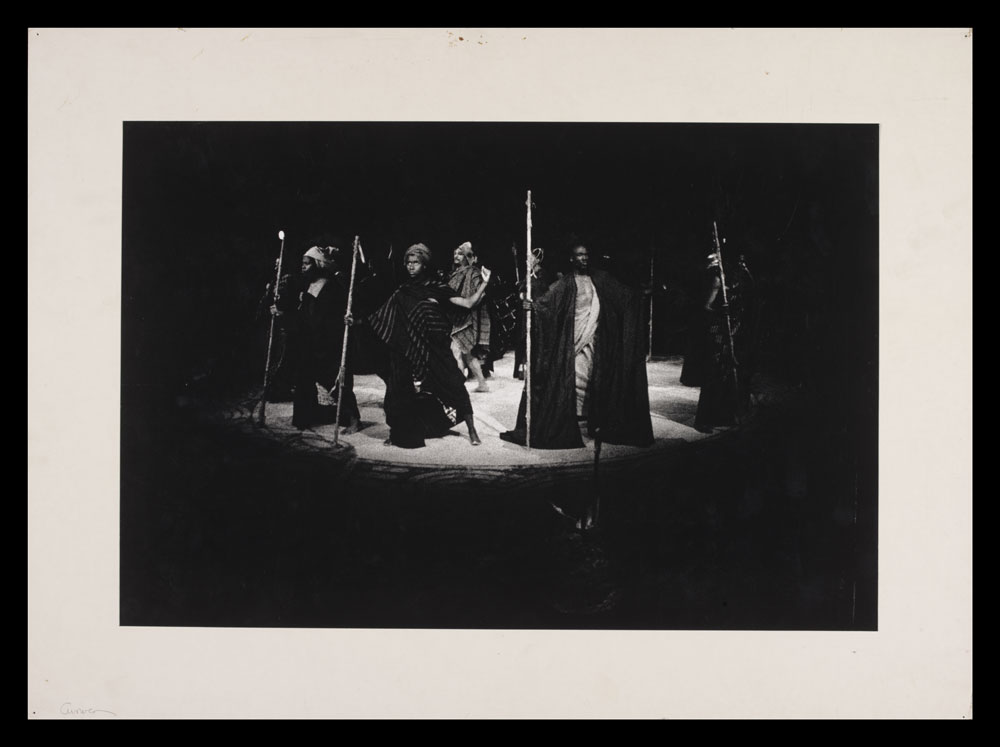 Photograph of actors on stage from the Gods are not to Blame